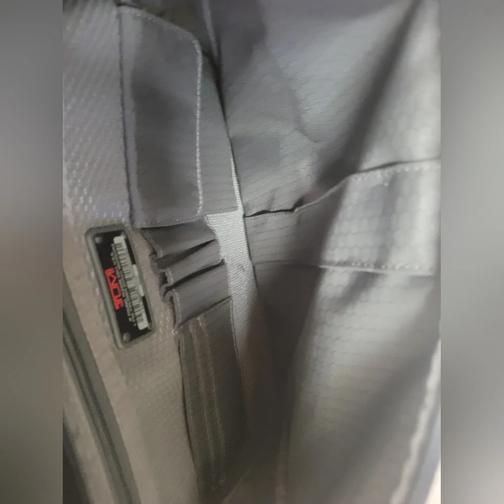 TUMI Black Backpack with Padded Straps and Multiple Compartments